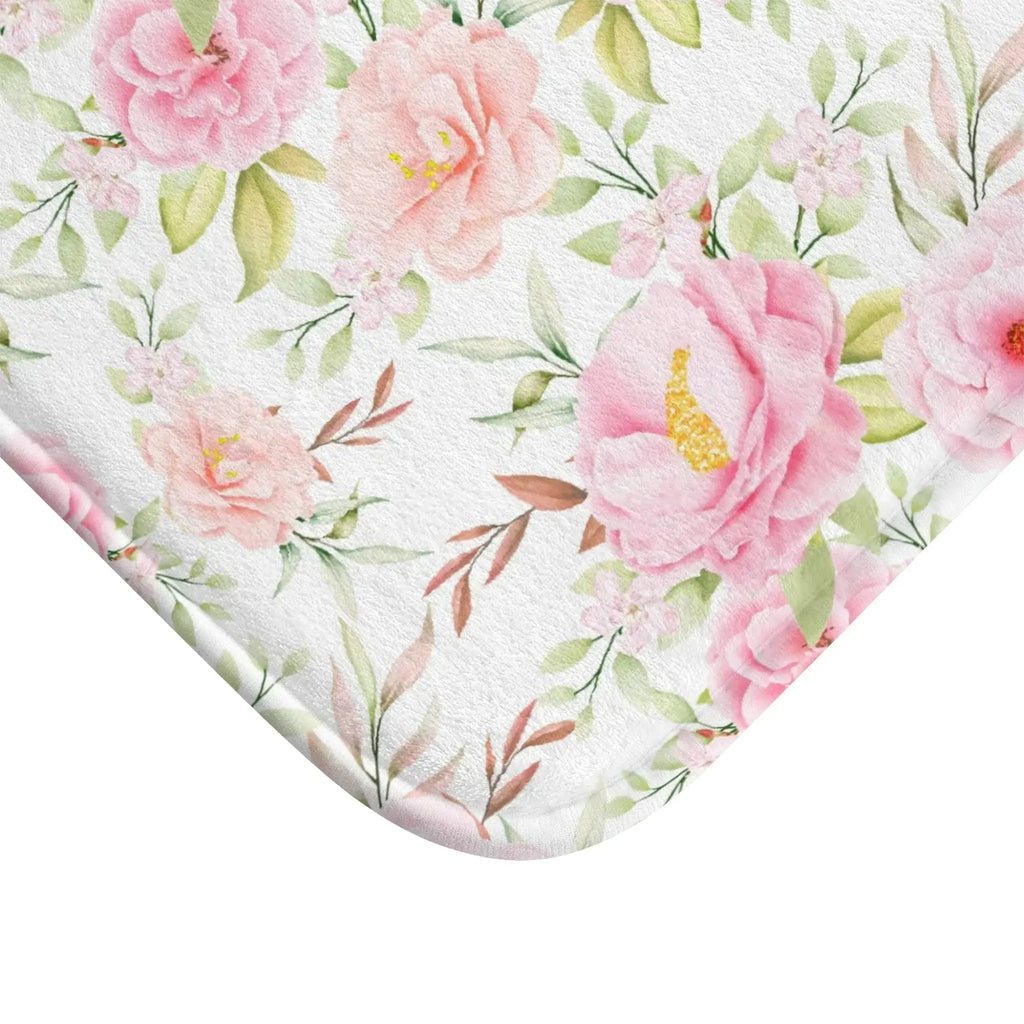 Texture detail of pink floral bath mat showing plush pile.