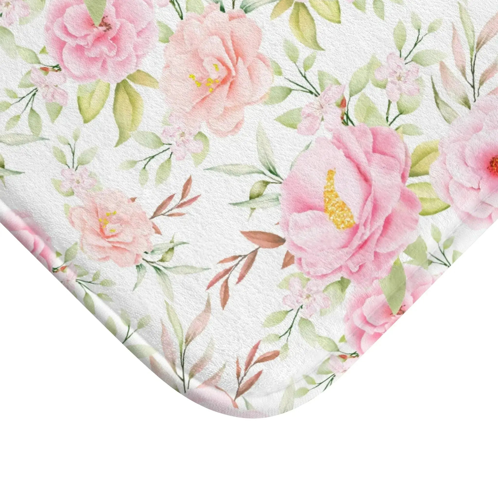 Texture detail of pink floral bath mat showing plush pile.