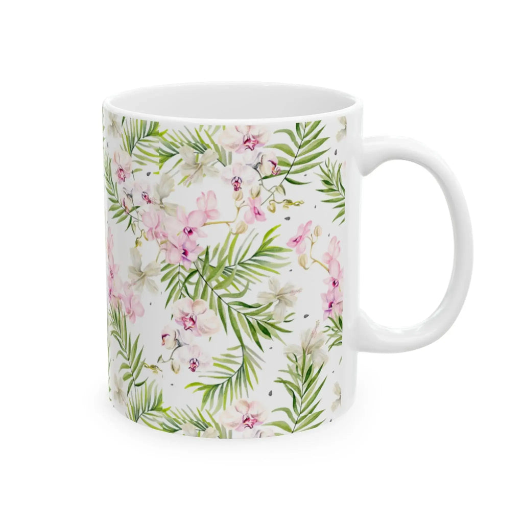 Closeup of pink and green tropical leaf design on coffee mug