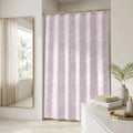 Pink tropical leaf shower curtain styled in a bright coastal bathroom
