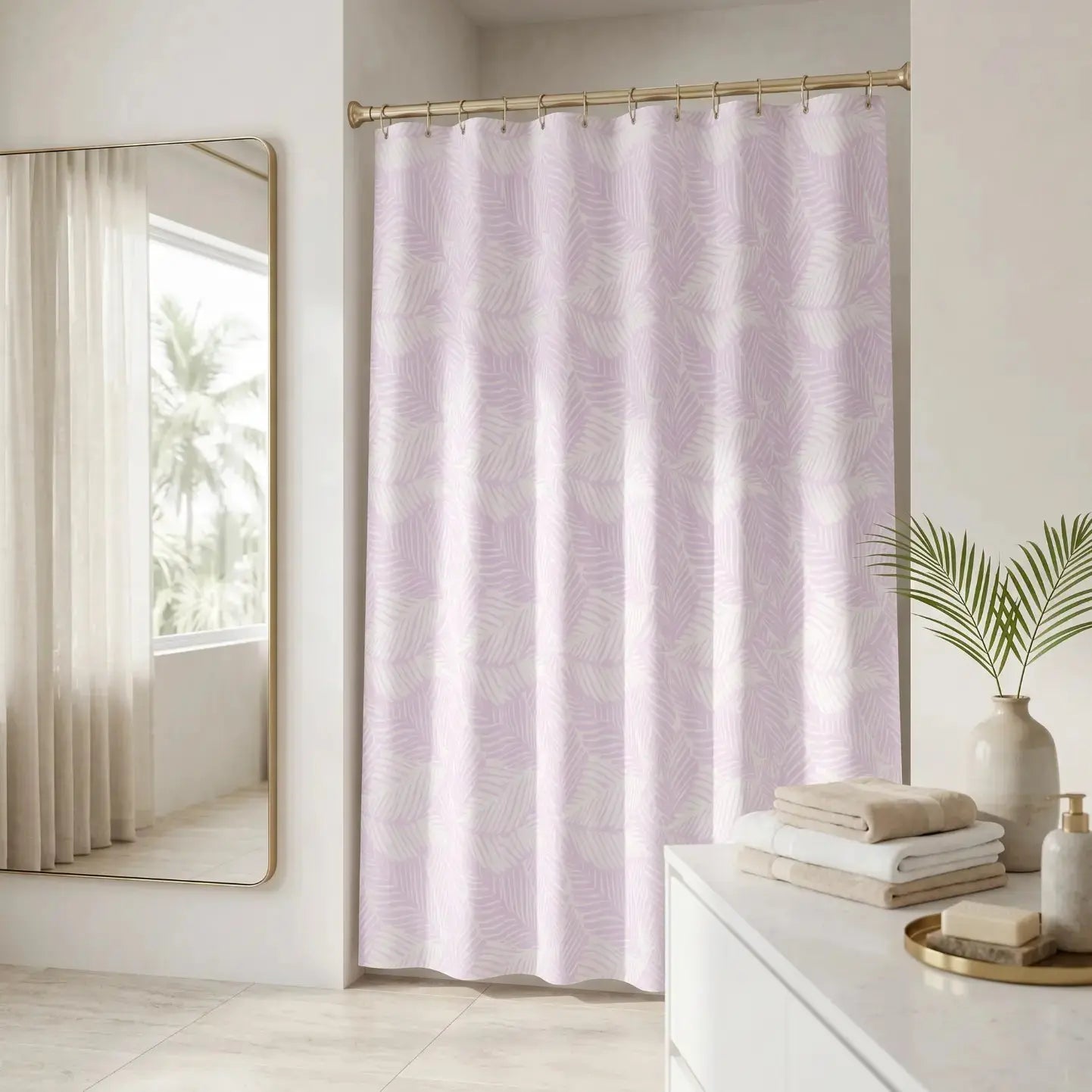 Pink tropical leaf shower curtain styled in a bright coastal bathroom