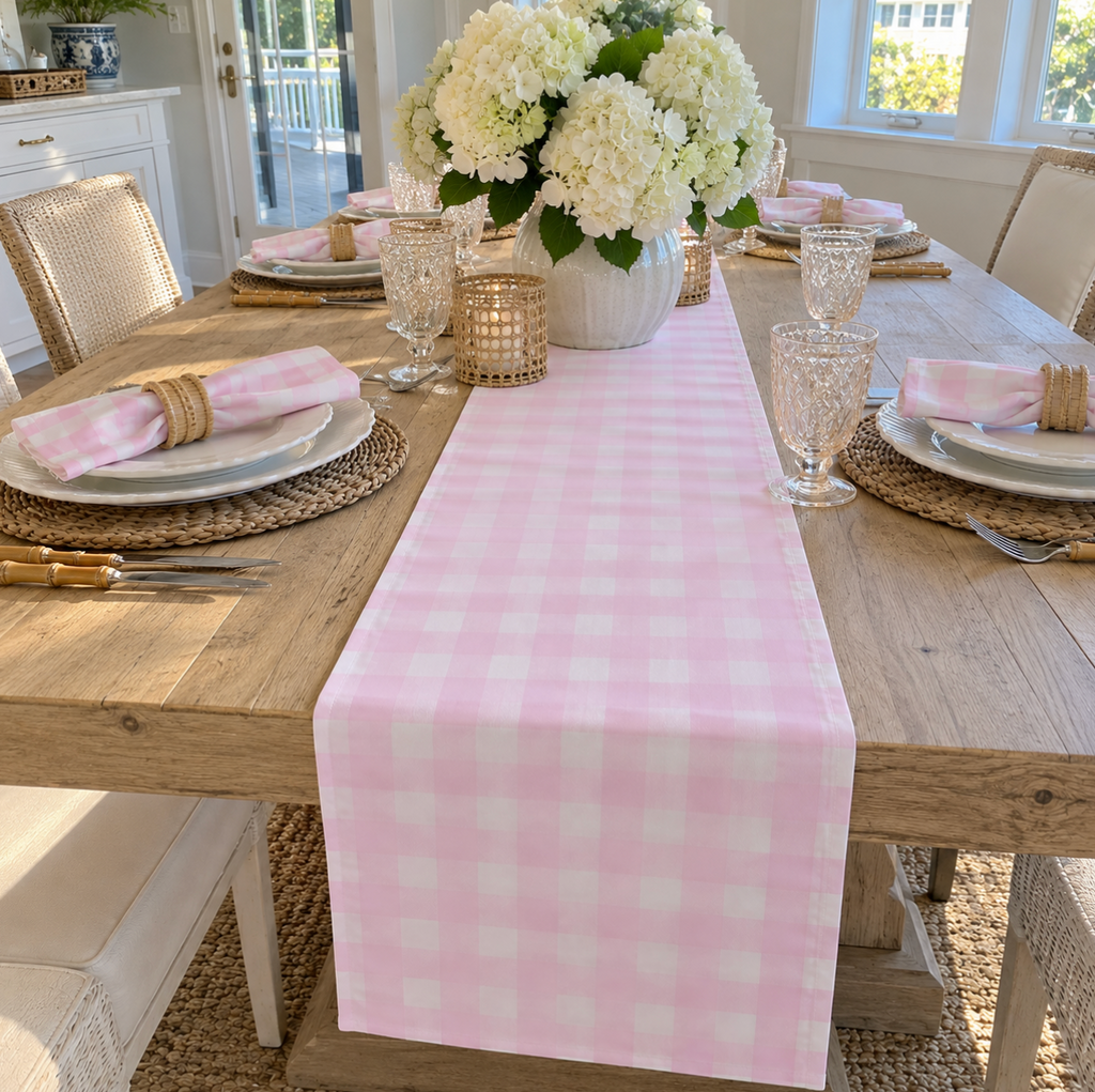 Preppy pink gingham table runner adding a classic touch to a dining table.
