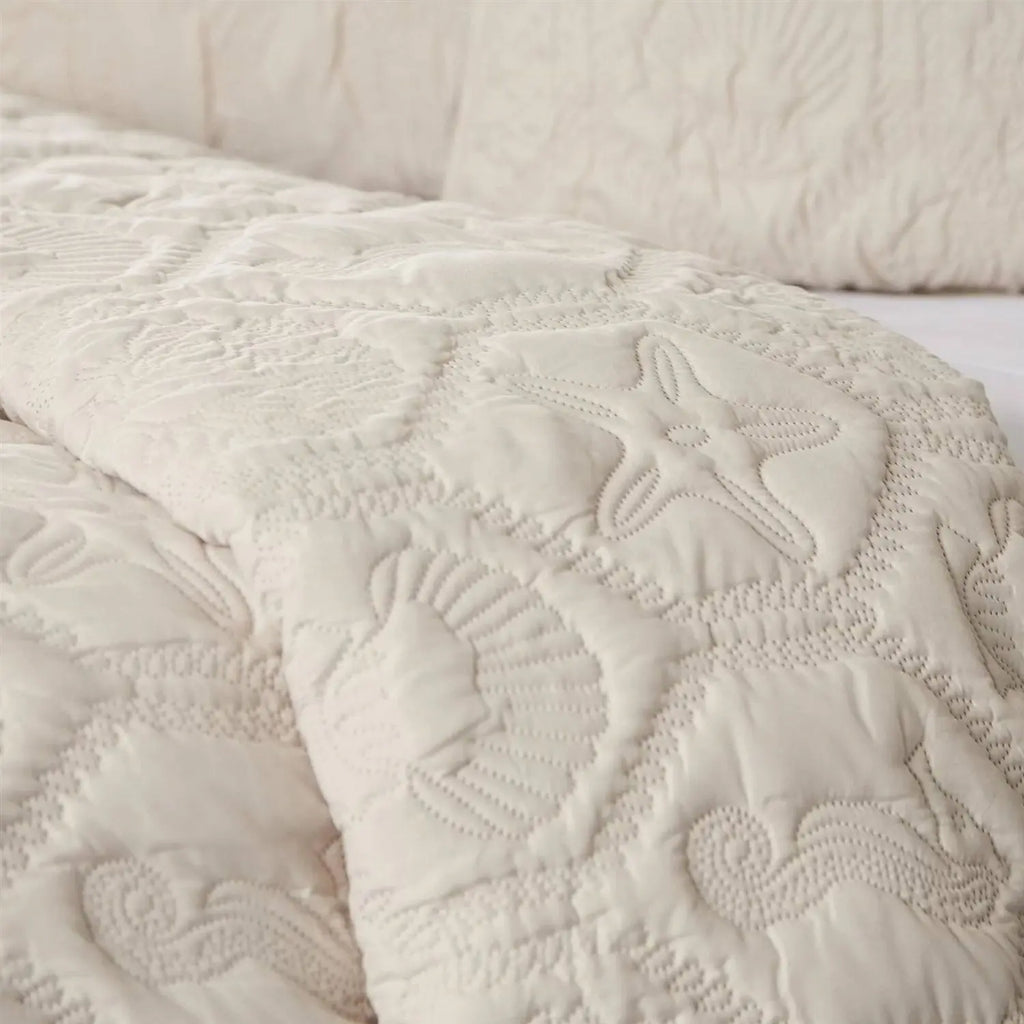 Closeup of queen coastal beach quilt set showing starfish, seashells, and seahorse details.