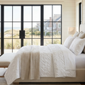 Queen white coastal beach quilt set with starfish, seashells, and seahorse pattern on a bed.