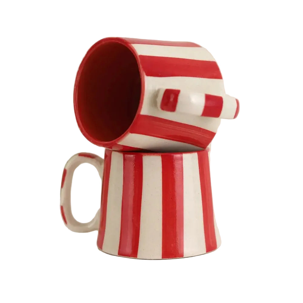 Closeup of red and white striped ceramic cup showing painted stripe detail.