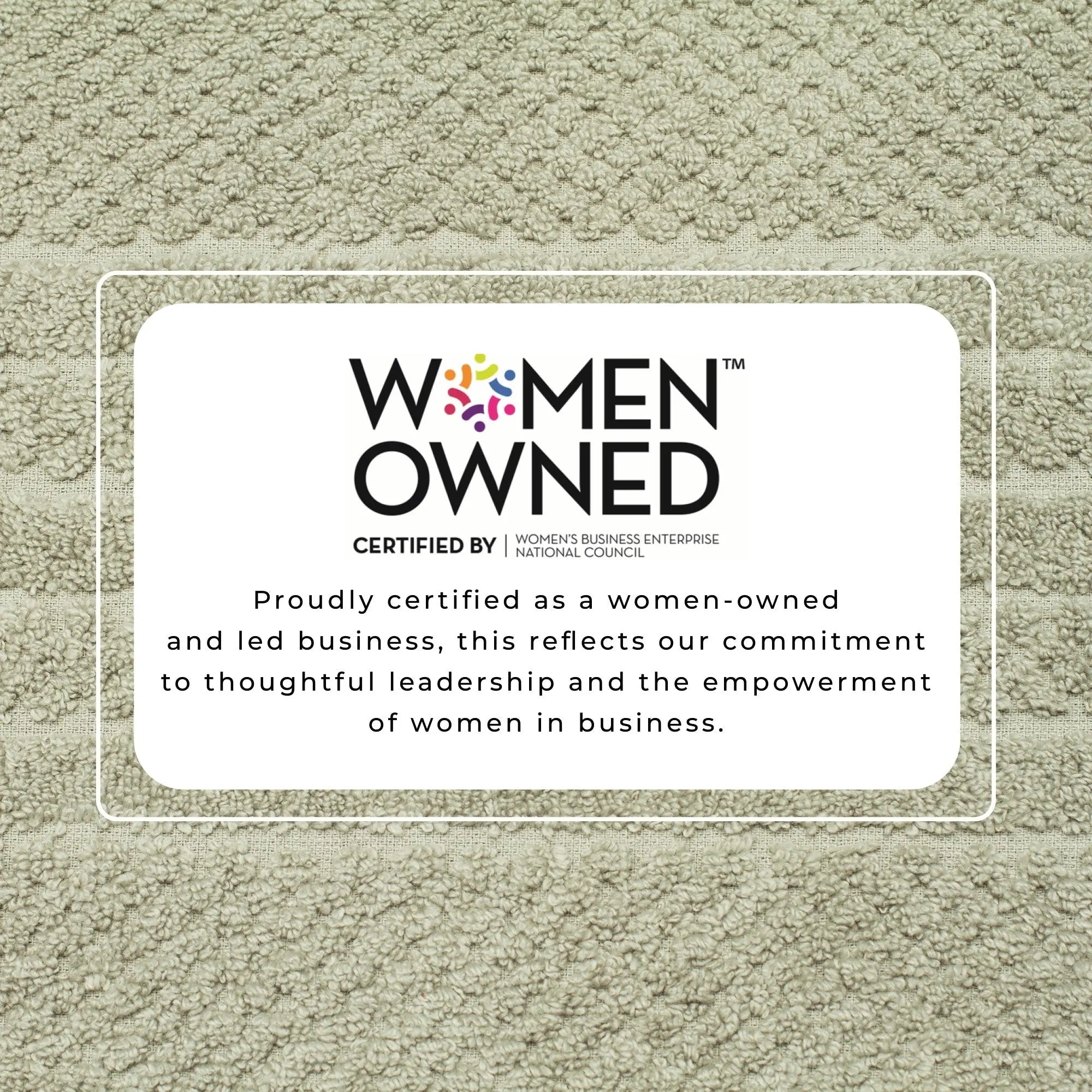 Bath towel set on beige towel background with Women-Owned certification badge.