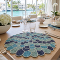 Multi‑tone blue and green beaded placemat forming a circular flower pattern for elegant table settings.