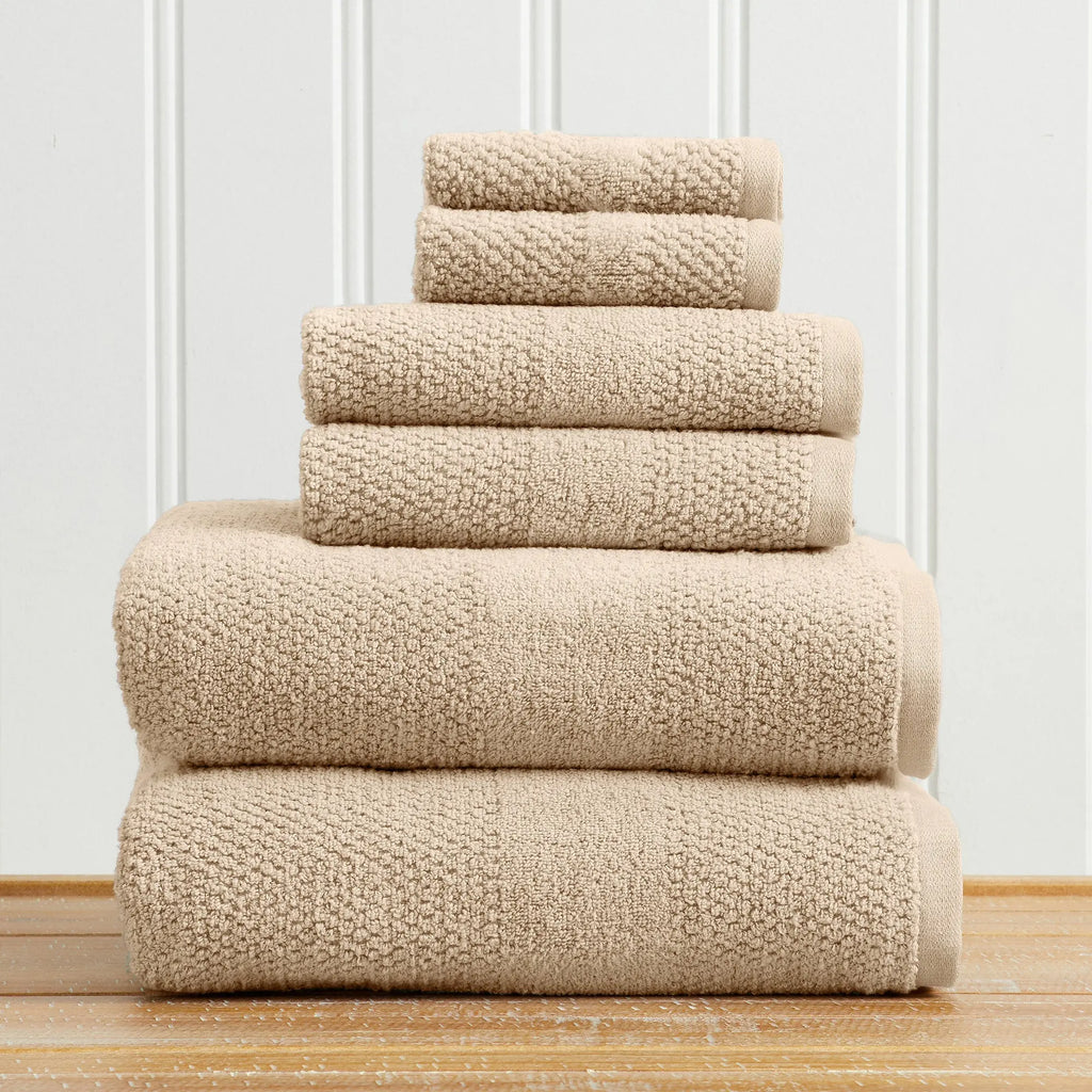 Great Bay Home Marbella Collection 5-piece bath towel set in beige, 100% cotton, stacked on a wood floor