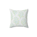 Sage green and blue botanical throw pillow in a coastal living room