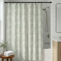 Sage green shower curtain with delicate palm tree motifs in a coastal tropical design.