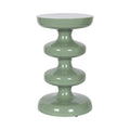Sculptural seafoam green side table bringing a calm, modern organic accent to a light-filled room.