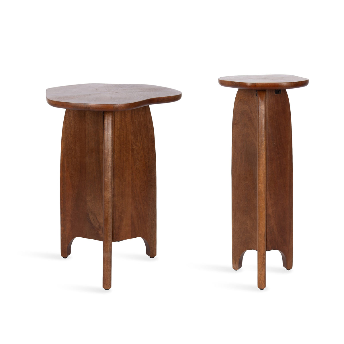 Sculptural wooden nesting side tables with curved pedestal bases and organically shaped tabletops for a modern interior.