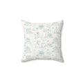 Light blue coastal toile throw pillow featuring seaside houses, palm trees, and sailboats pattern.