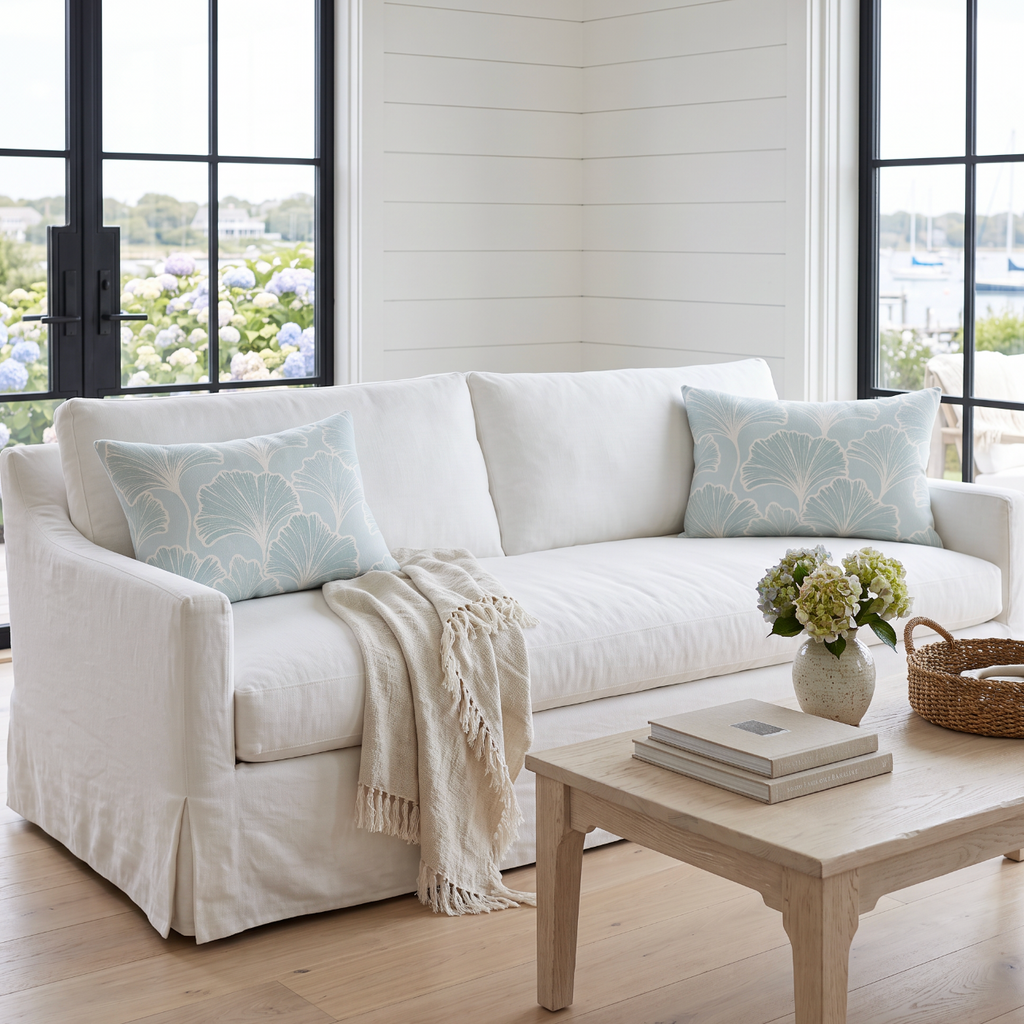 Seafoam leaf pattern lumbar throw pillow adding soft coastal color to a modern beach house sofa