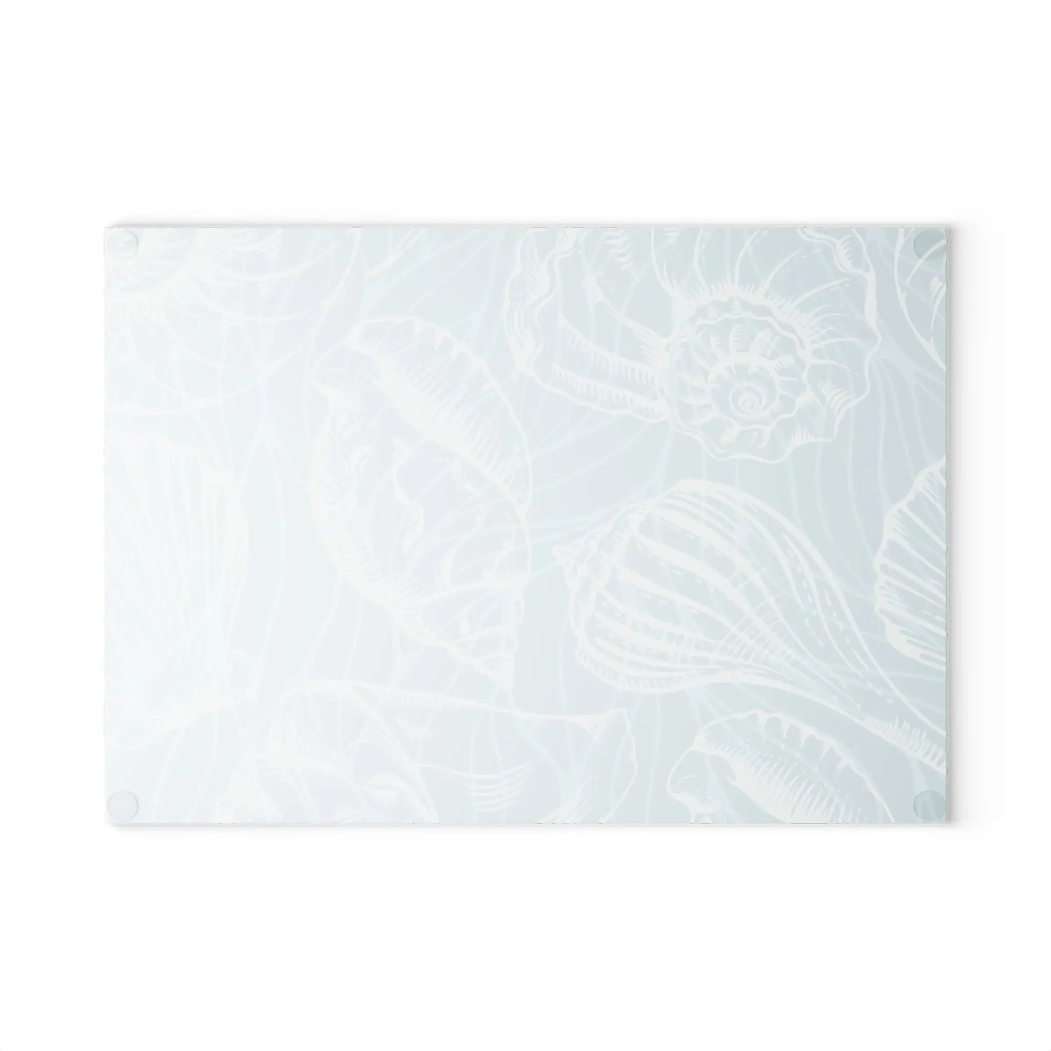 Coastal seashell glass cutting board in pale seafoam with white shell outlines.