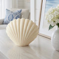 seashell shaped soy candle styled on coastal coffee table