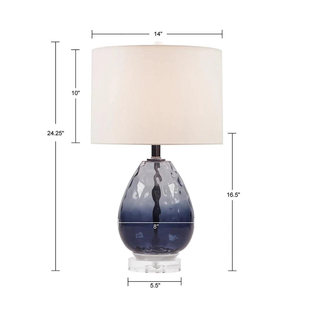 Sculptural blue ombre glass lamp bringing soft coastal elegance to a bedroom