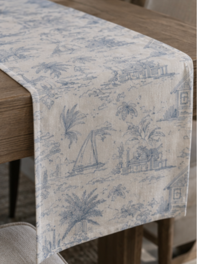 Seaside sailboat table runner with blue coastal toile artwork on a warm ivory ground