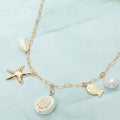 Coastal shell pearl fish starfish charm paperclip chain necklace shown as beach inspired everyday jewelry