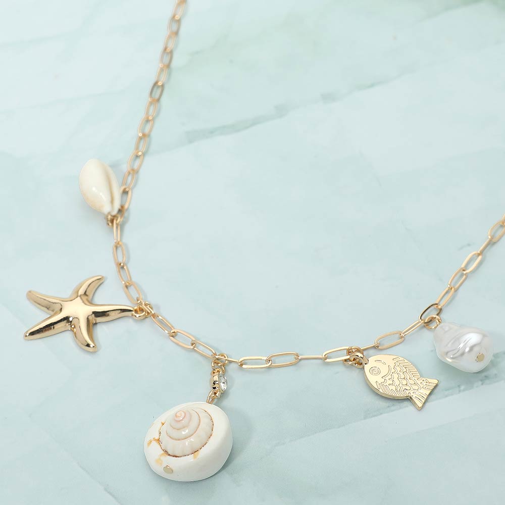Coastal shell pearl fish starfish charm paperclip chain necklace shown as beach inspired everyday jewelry