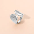 Silver stainless steel seashell adjustable ring shown as beach inspired everyday jewelry