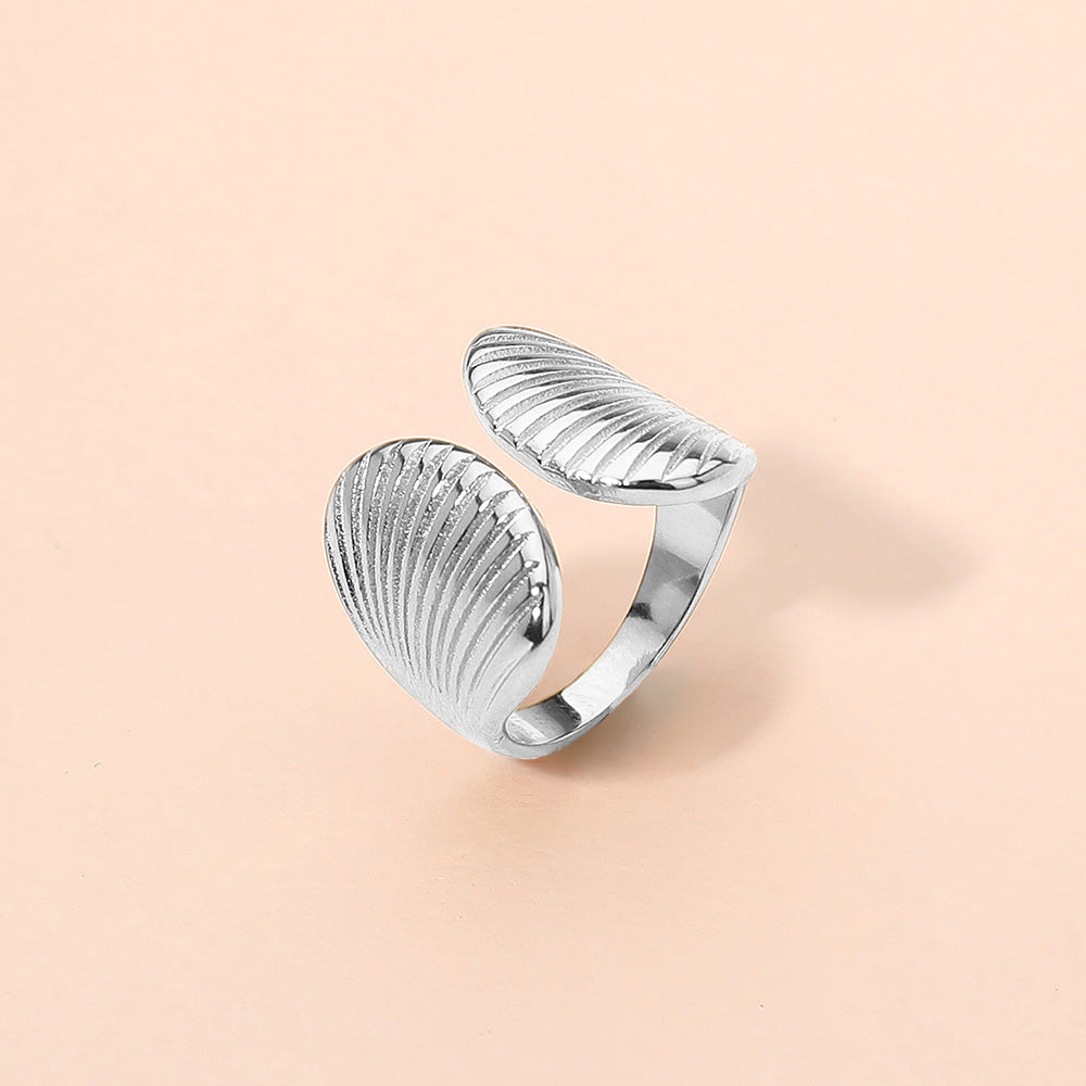 Silver stainless steel seashell adjustable ring shown as beach inspired everyday jewelry