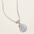 Delicate silver seashell charm necklace shown as beach inspired everyday jewelry