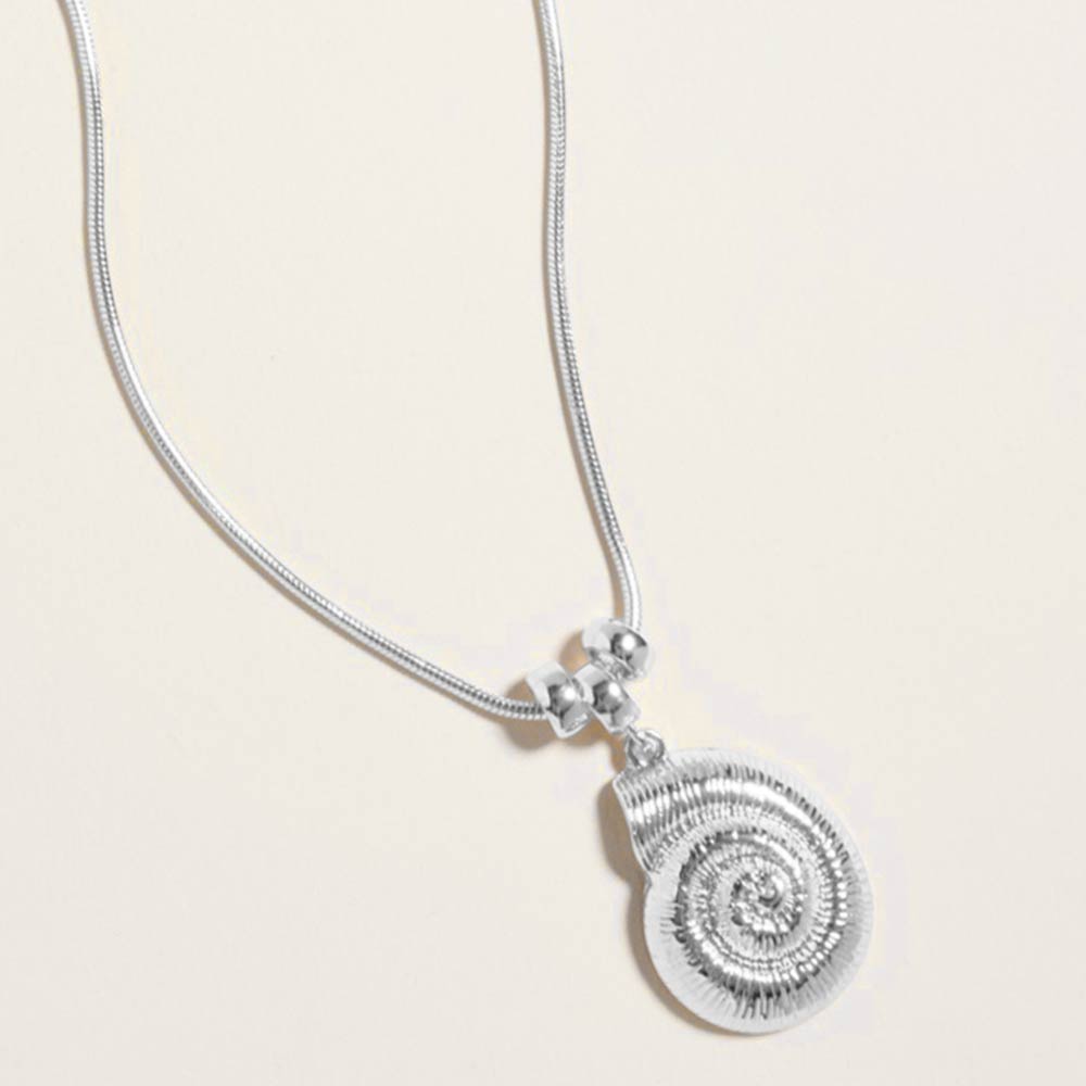 Delicate silver seashell charm necklace shown as beach inspired everyday jewelry