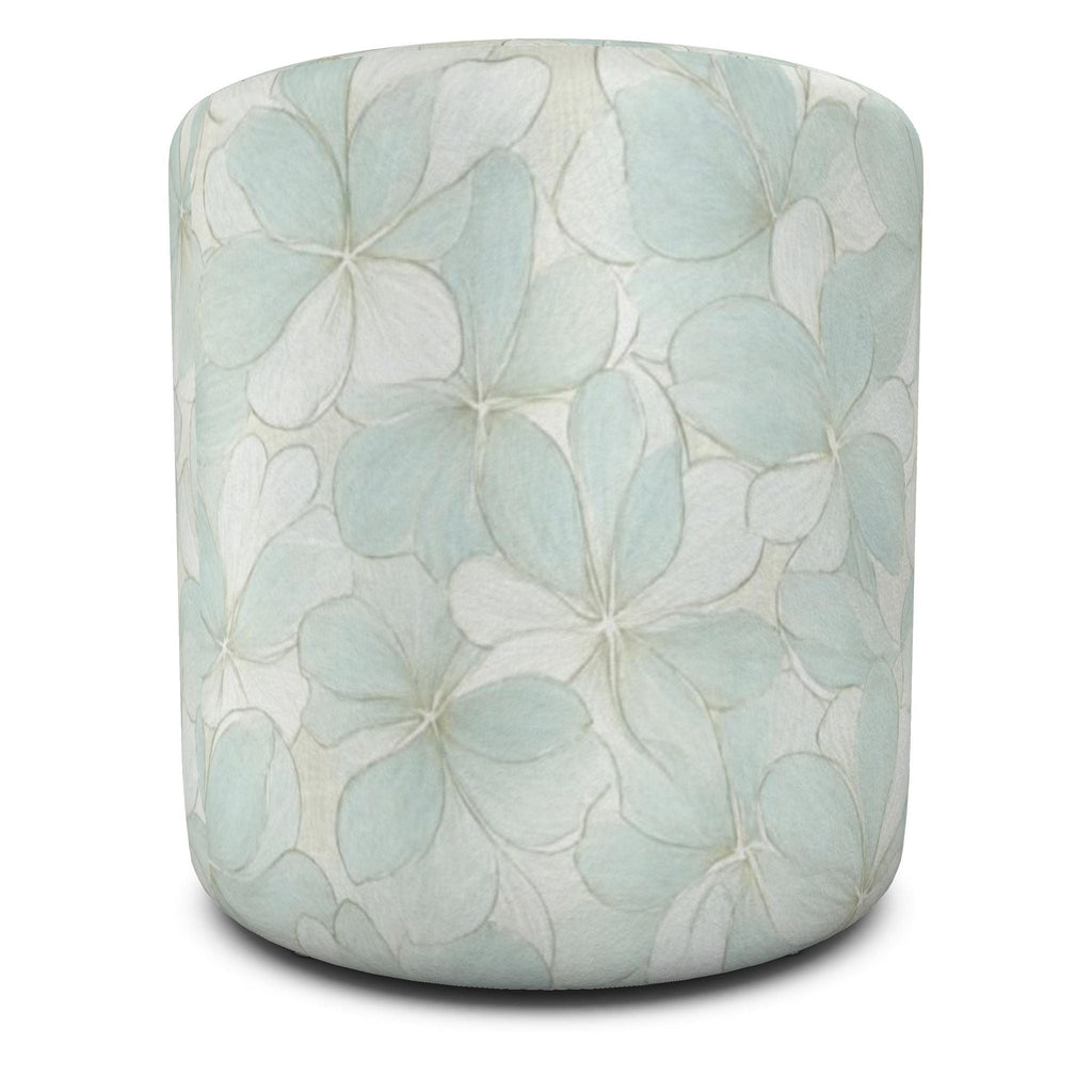 Coordinating upholstered ottoman pair with a soft blue floral motif for a beach house or cottage living room.