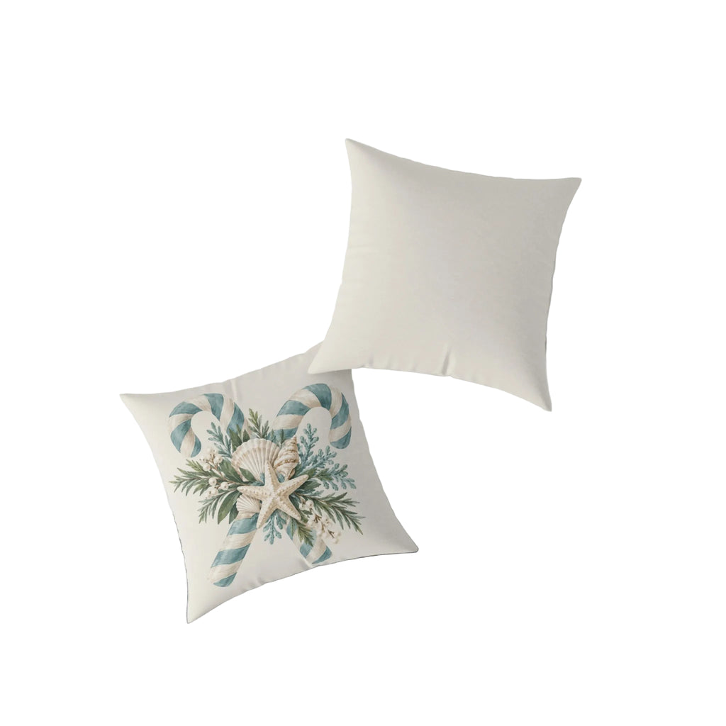 Beach house Christmas throw pillow with a cream starfish and seashells nestled in sage green foliage and crossed striped candy canes