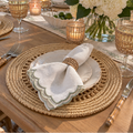 Tan and neutral woven placemats styled on an elegant dining table.