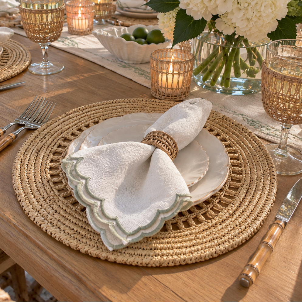 Tan and neutral woven placemats styled on an elegant dining table.
