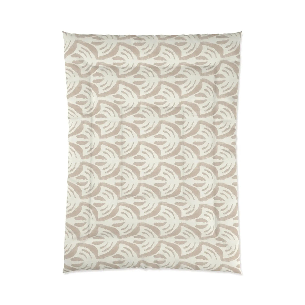 Tan pattern comforter on a bed in a light, airy beach house bedroom