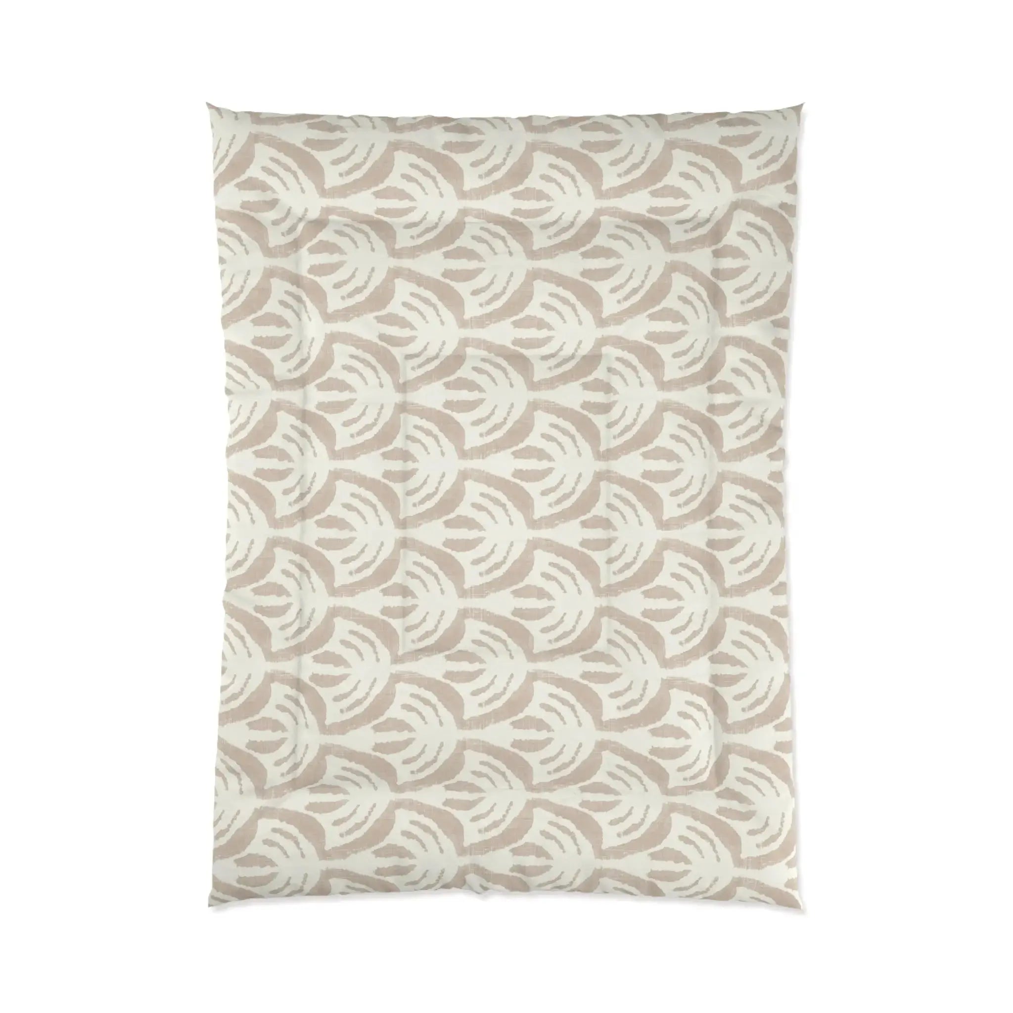 Tan pattern comforter on a bed in a light, airy beach house bedroom