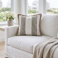 Square accent pillow with woven stripes and decorative edge trim that outlines the silhouette.
