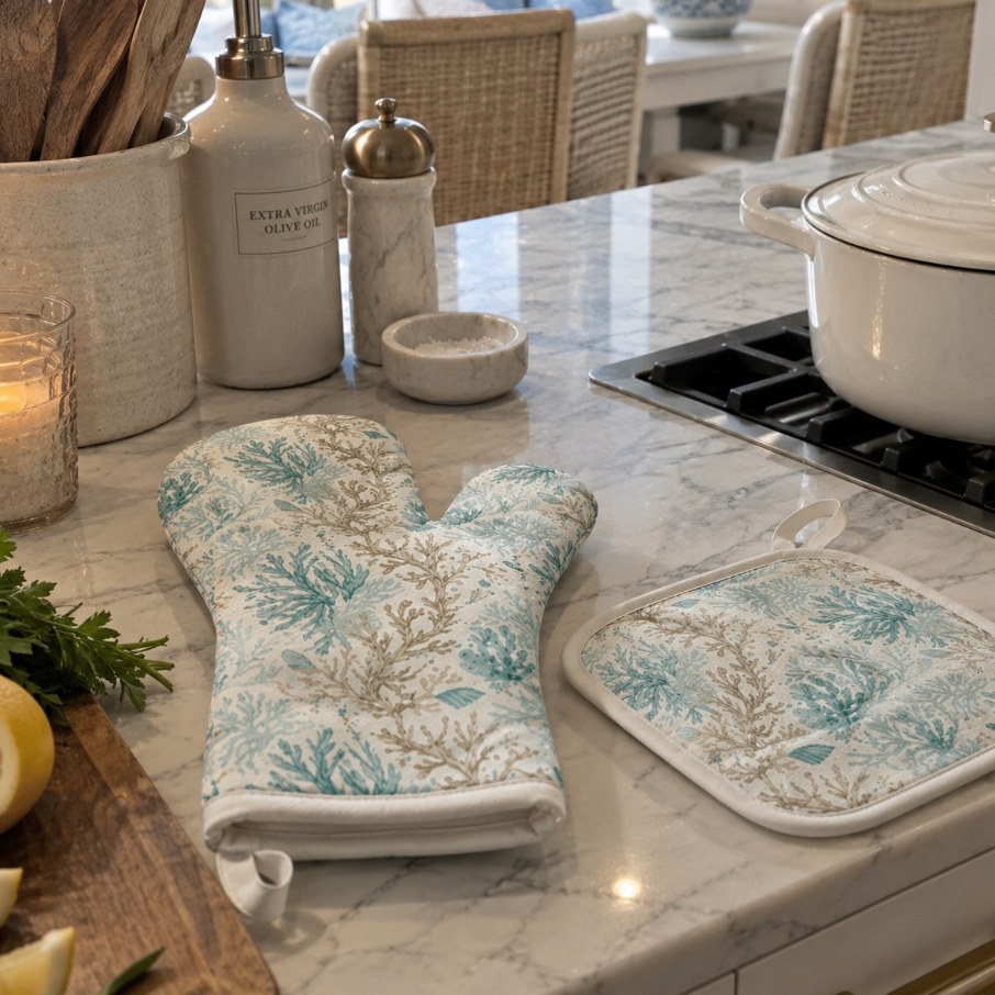 Two-piece kitchen linen set featuring a watercolor coral branch pattern oven mitt and pot holder