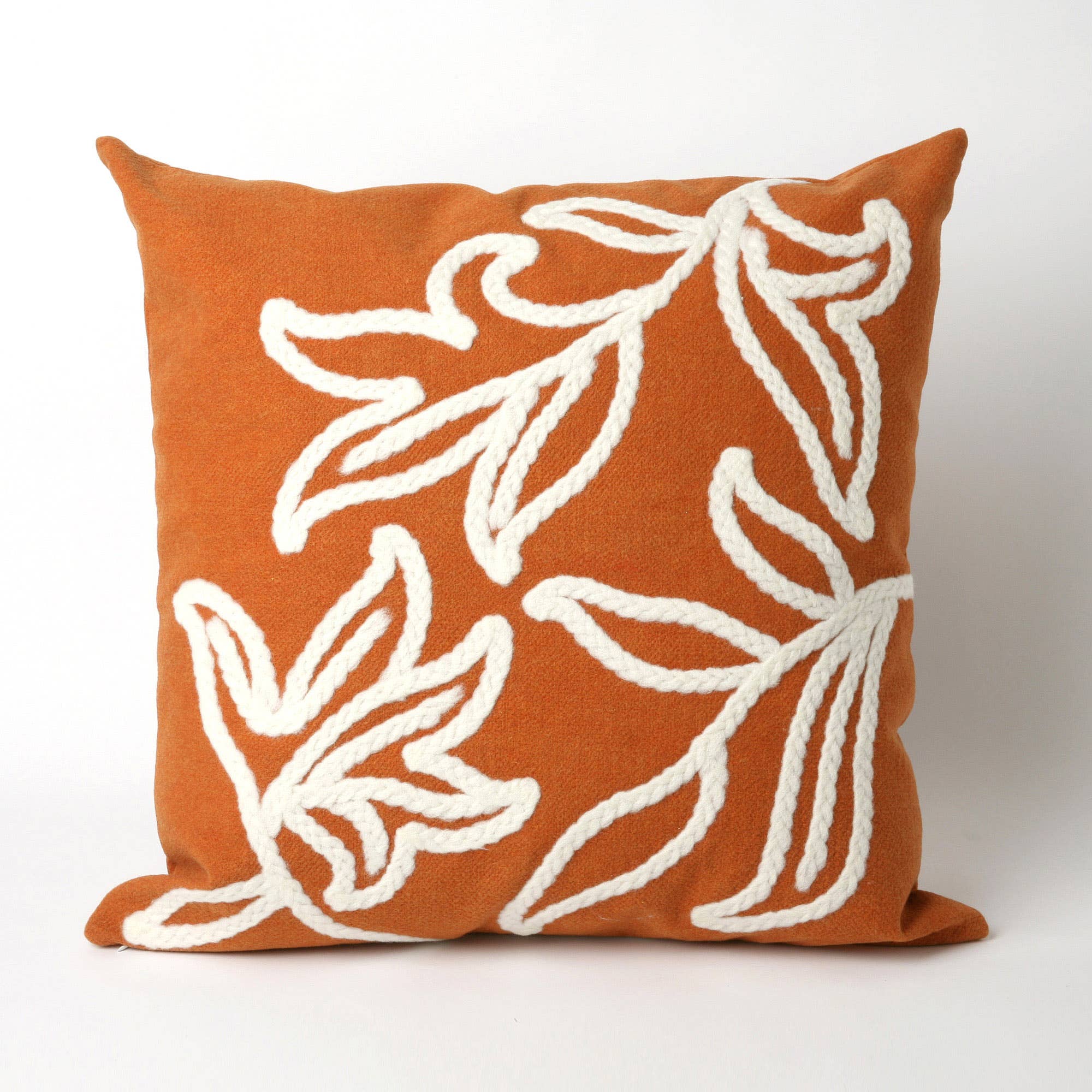 Rust orange and cream botanical cushion that pairs beautifully with neutral throws, wood, and woven accents.