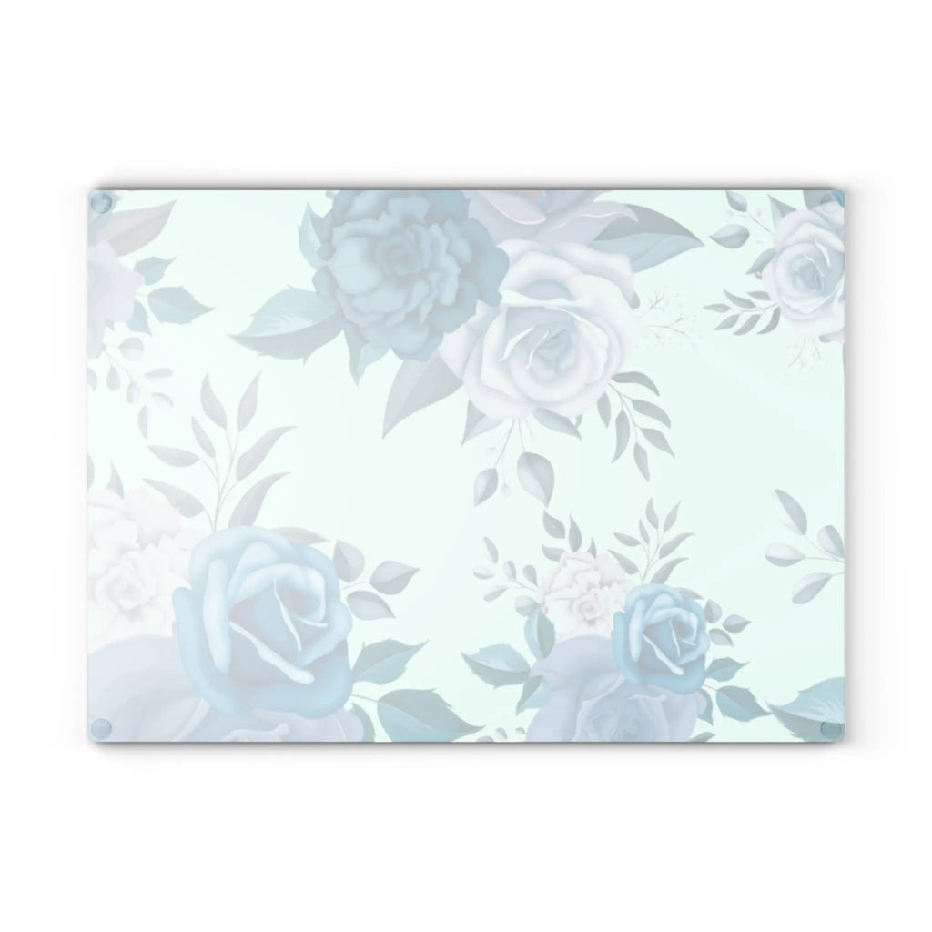 Blue floral glass cutting board with soft teal roses on a pale mint background.
