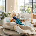 Toucan Iraca palm napkin ring on a linen napkin for artisan coastal table decor