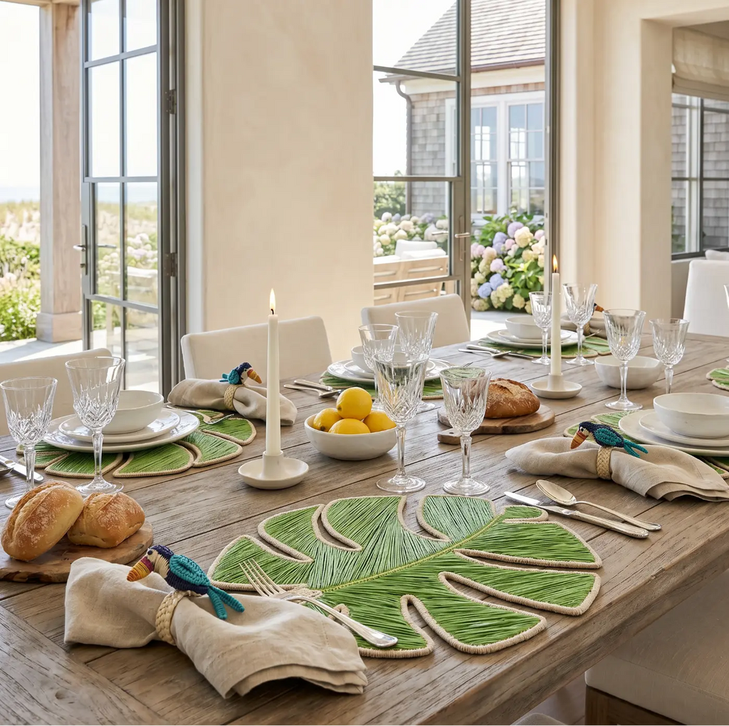 Set of Monstera Leaf Iraca placemats arranged for a tropical coastal table setting