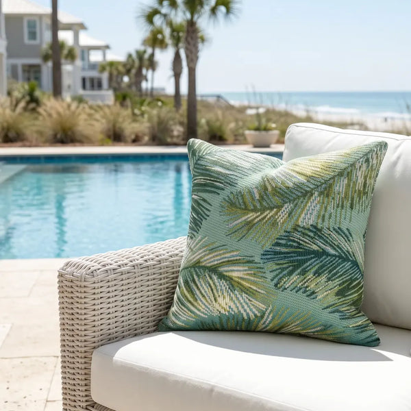 Tropical palm leaf pillow in blue tones with weather-resistant fabric