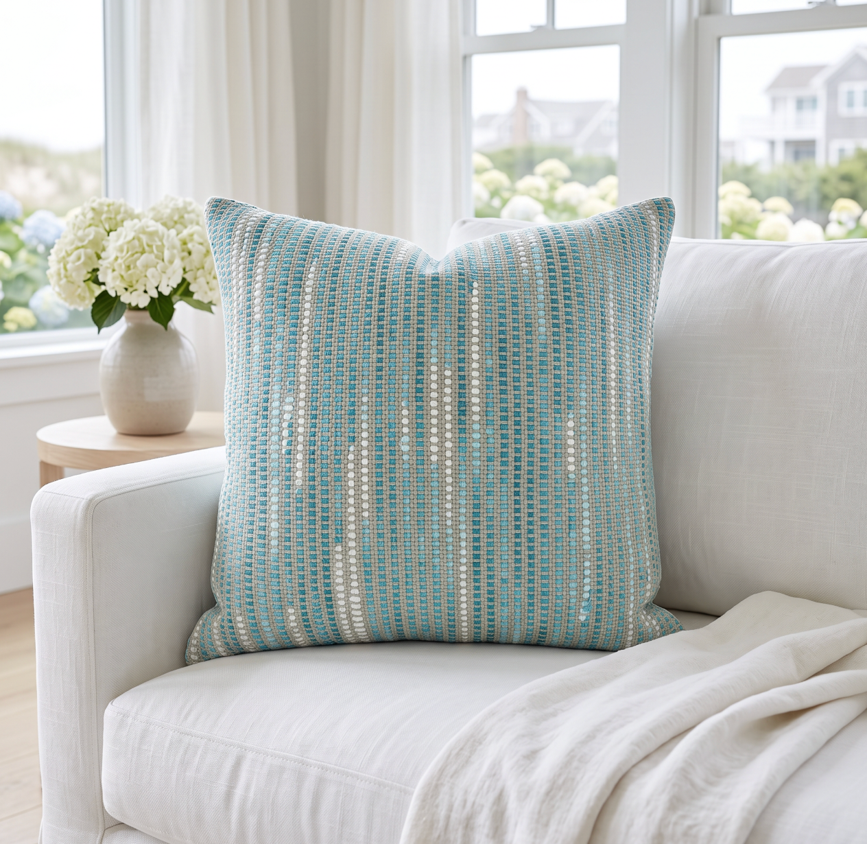 Bright aqua and turquoise woven stripe pillow offering playful color and woven texture in living rooms.

