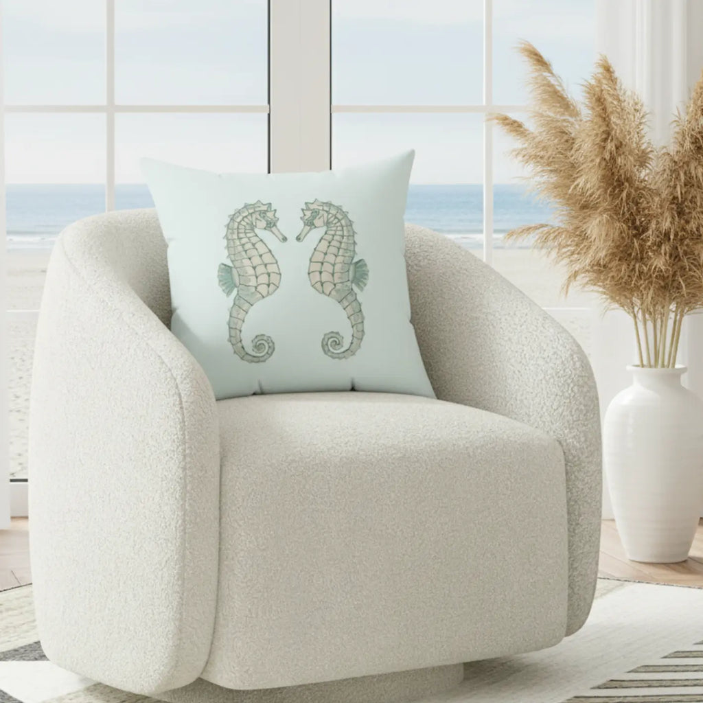 Twin Seahorse Throw Pillow features two delicately illustrated seahorses on pale aqua background.
