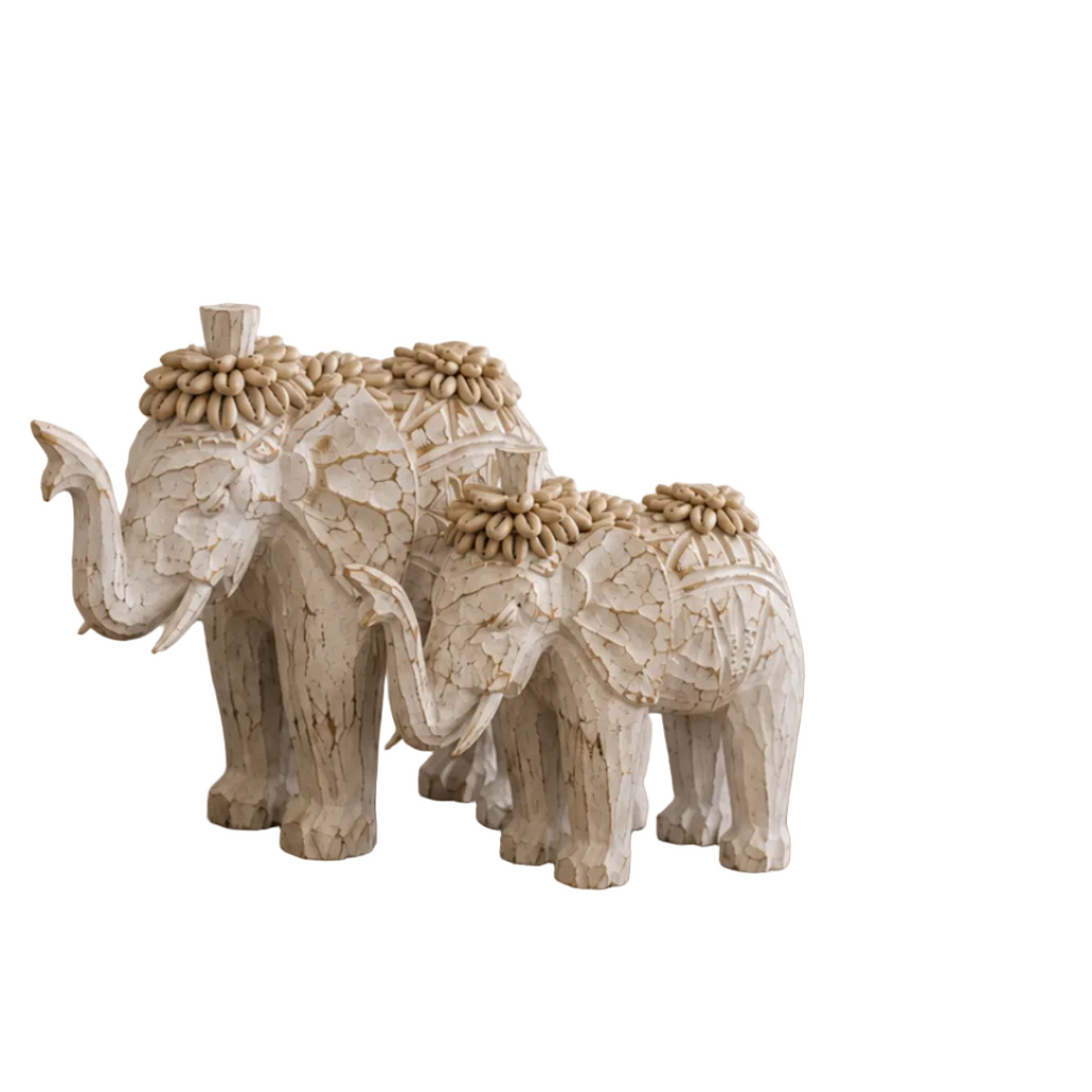 Side view of a handcrafted-style shell elephant sculpture highlighting its textured body and sculptural silhouette.