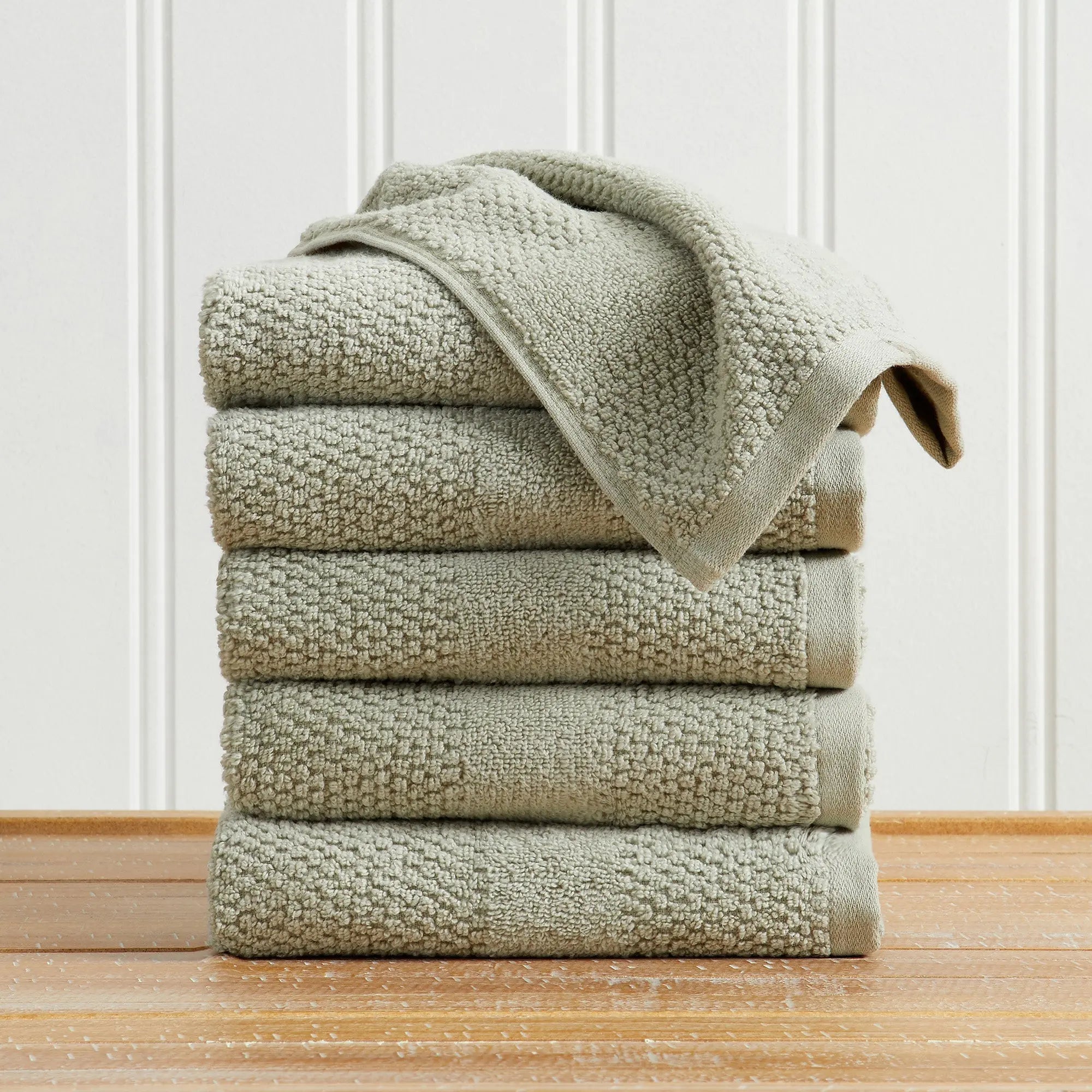 Bath towel set by Great Bay Home Marbella Collection; 100% cotton, woven-texture beige towels, stack of five.