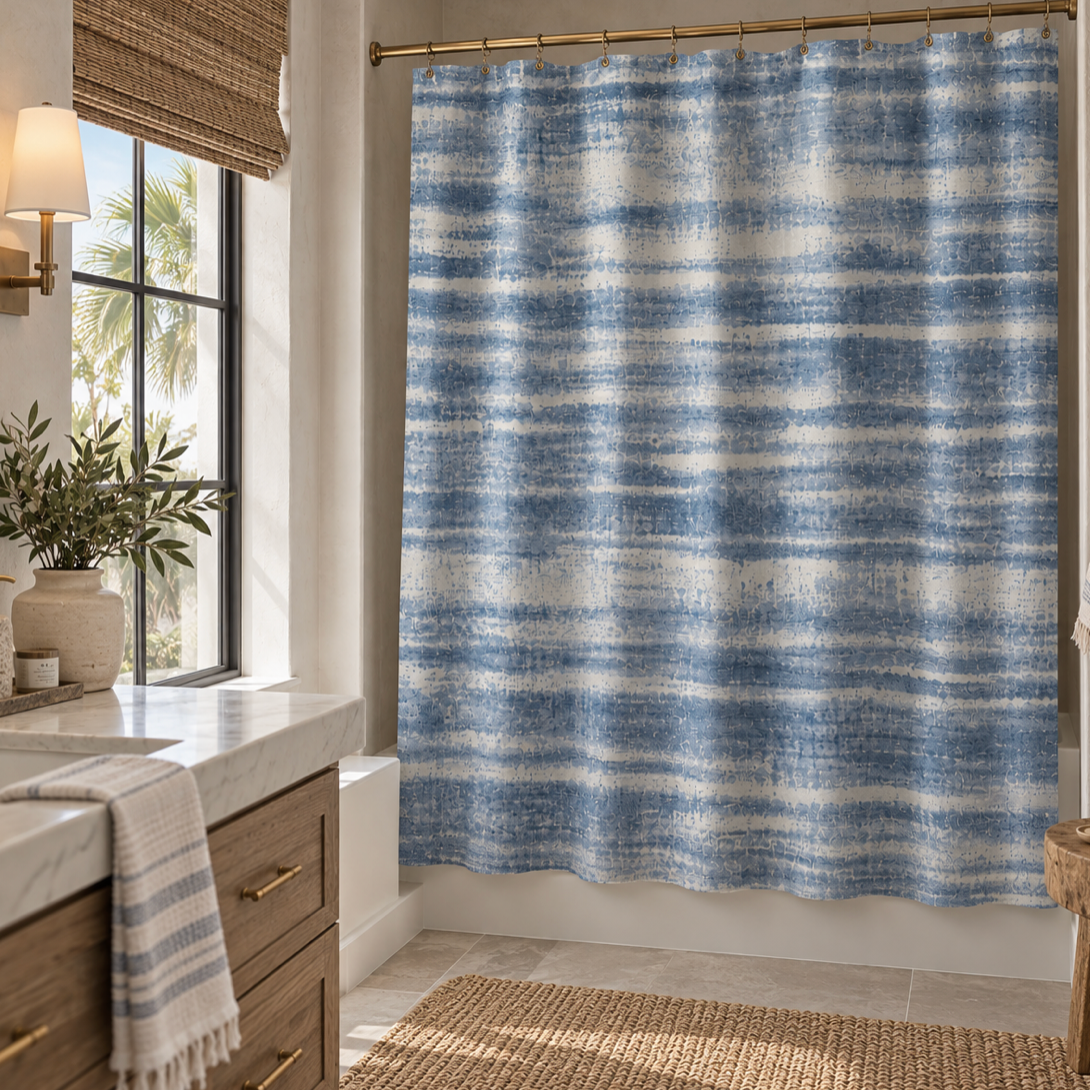 Blue washed striped shower curtain styled in a beach house bathroom