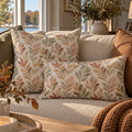 Elegant botanical pillow with soft green and rose leaves beside French doors