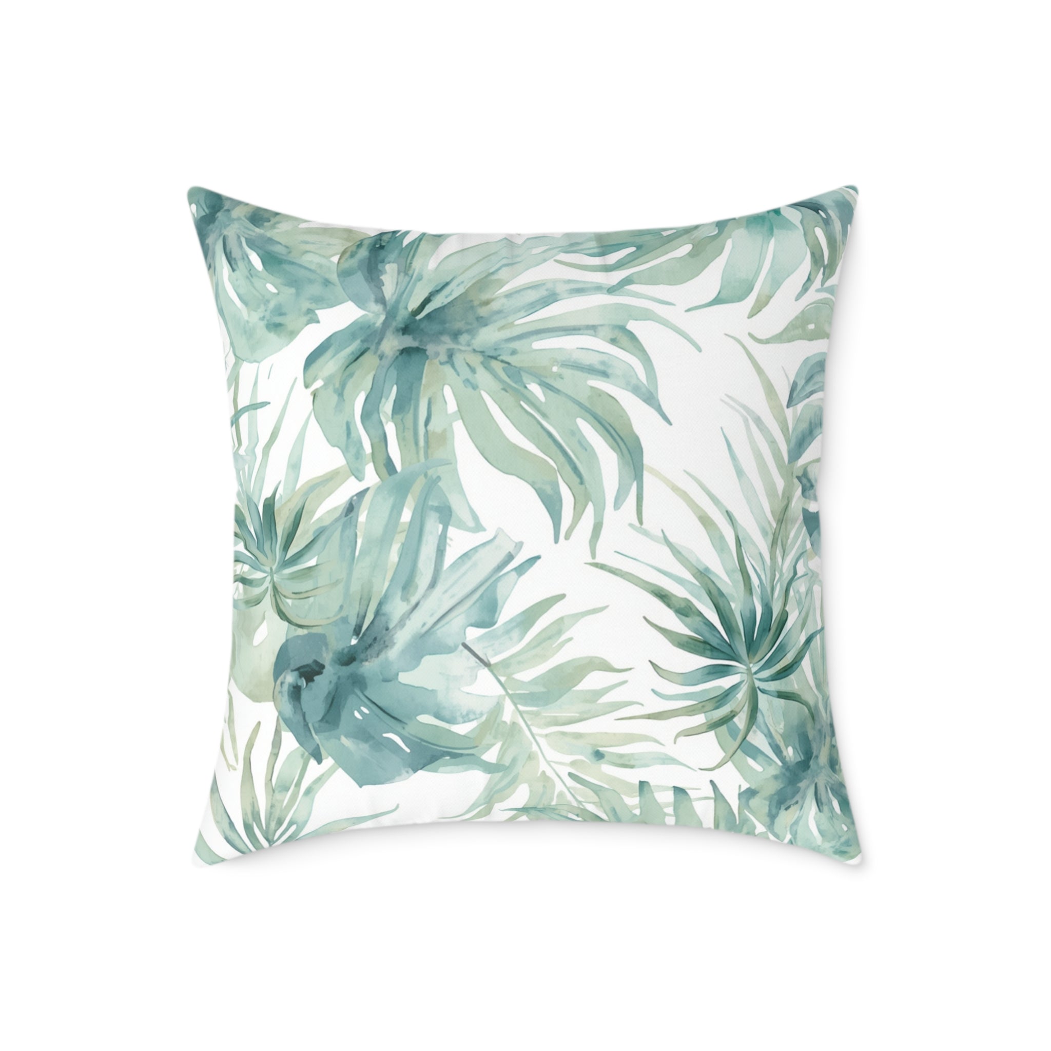 Modern coastal throw pillow featuring a watercolor palm frond design on a light background.