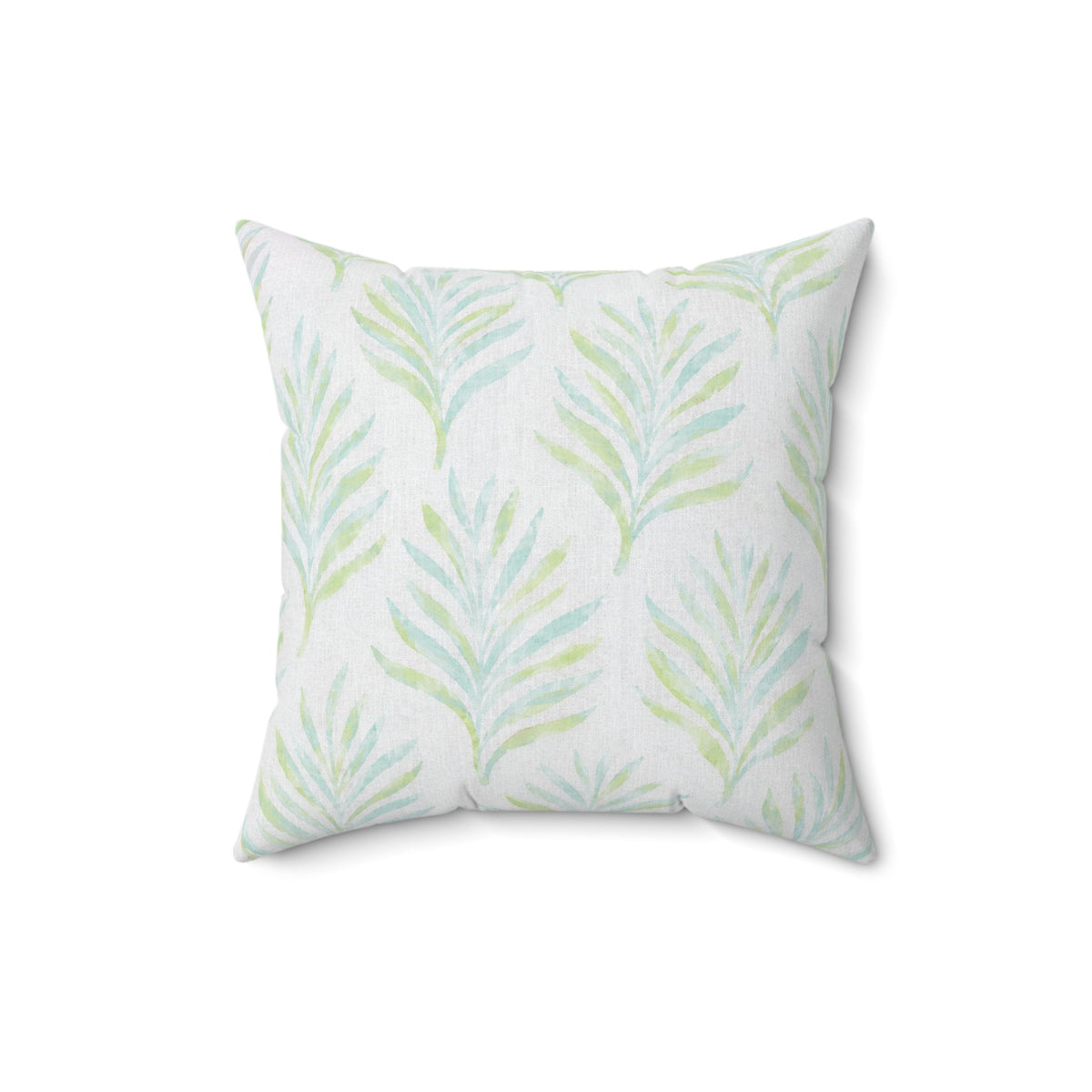 White decorative pillow with blue and green palm leaf patterns