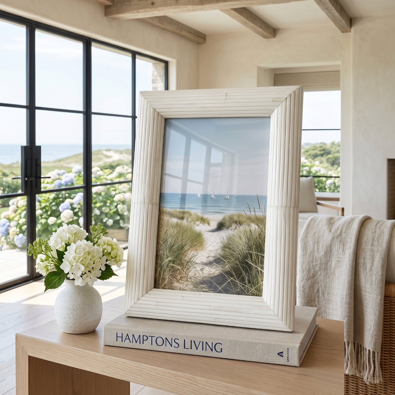 White bone inlay picture frame holding a 4x6 photo styled on a coastal console table